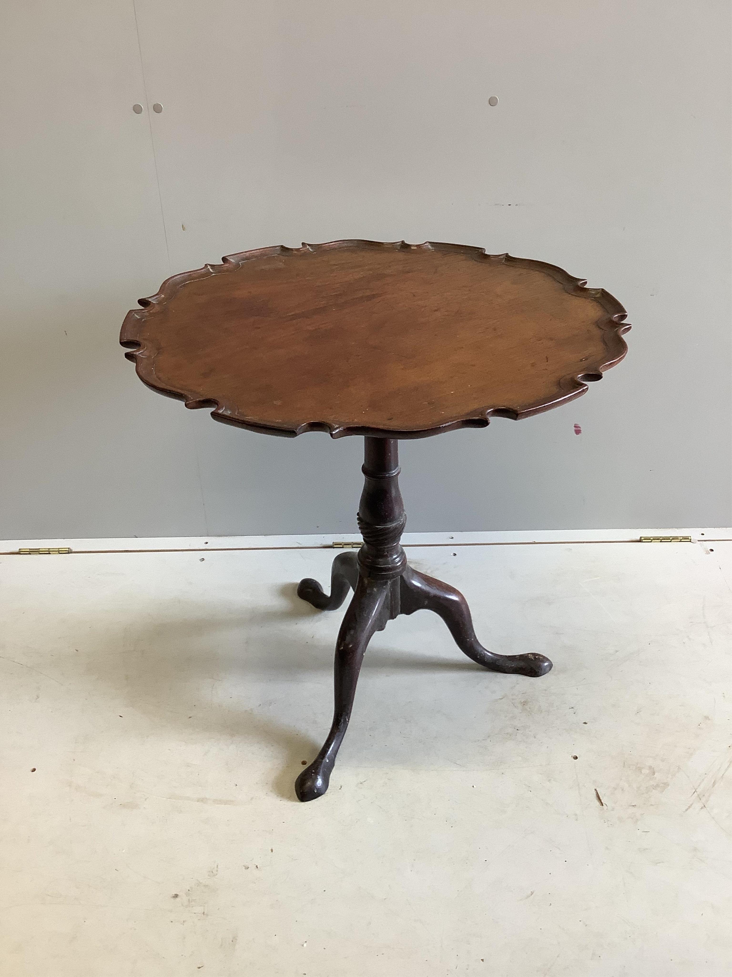 A George III circular mahogany tilt top tea table, diameter 70cm, height 68cm. Condition - fair